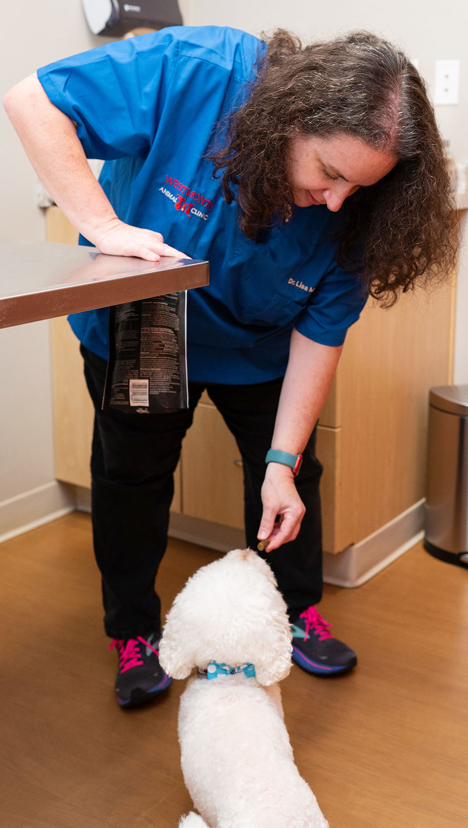 Dr. Matagrano giving a treat to a dog