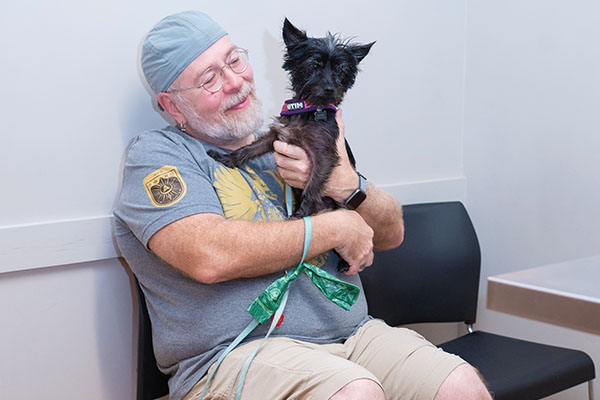 owner with small dog waiting vaccines